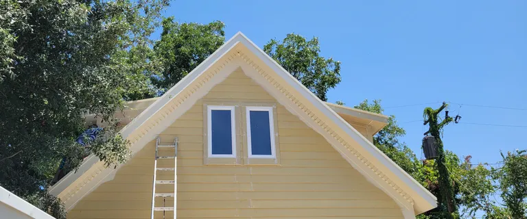 The gable end, with the fascia and frieze detailing carried around all four sides.