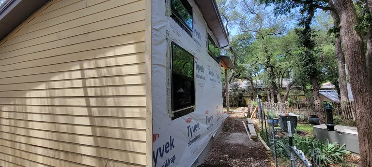 House wrap on and taped, in the side yard.
